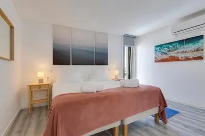 a bedroom with a large bed with two pillows at NEW Salema Seaview in Salema