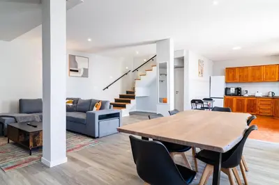 a dining room and living room with a table and chairs at GuestReady - Escape with Ocean and Mountain Views in Calheta
