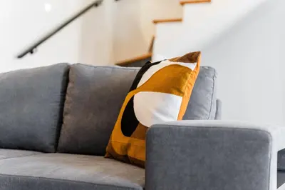 a blanket sitting on top of a gray couch at GuestReady - Escape with Ocean and Mountain Views in Calheta