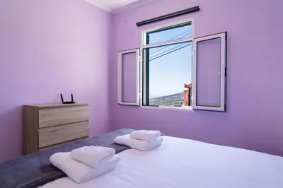 a bedroom with two towels on a bed with a window at GuestReady - Escape with Ocean and Mountain Views in Calheta