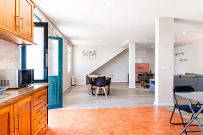 an open kitchen and living room with a dining room at GuestReady - Escape with Ocean and Mountain Views in Calheta