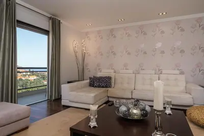 a living room with a white couch and a table at Design Gardens Nº2 in Bicas