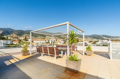 a pavilion on the roof of a building with benches at Design Gardens Nº2 in Bicas