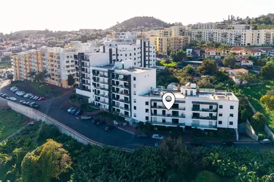 an aerial view of a large white building in a city at Design Gardens Nº2 in Bicas