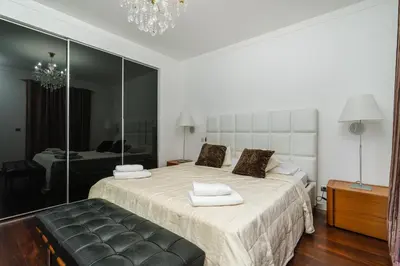 a bedroom with a large bed and a mirror at Design Gardens Nº2 in Bicas