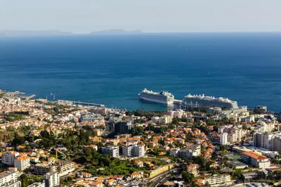 a city with a cruise ship in the water at Design Gardens Nº2 in Bicas