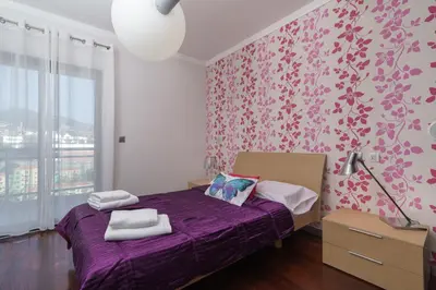 a bedroom with a purple bed with a purple blanket at Design Gardens Nº2 in Bicas