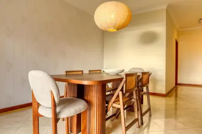 a dining room with a wooden table and chairs at Emma's Place, a Home in Madeira in Funchal