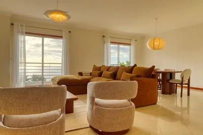 a living room with a couch and chairs and a table at Emma's Place, a Home in Madeira in Funchal