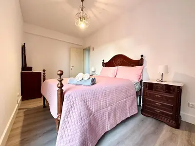 a kitchen with wooden cabinets and a white appliance at Santa Luzia pokoje in Funchal