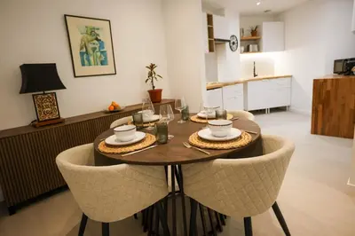 a table in a living room with chairs around it at Dona Mécia in Funchal