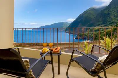 a balcony with chairs and a view of the water at Casa Alba - Sunrise and Sea View Balcony - Apt 1 in Seixal