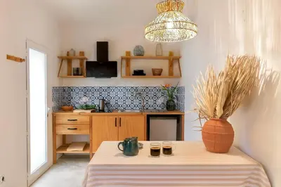 a kitchen with a table with a vase on it at Casa Alba - Sunrise and Sea View Balcony - Apt 1 in Seixal