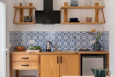 a kitchen with a sink and a tile wall at Casa Alba - Sunrise and Sea View Balcony - Apt 1 in Seixal