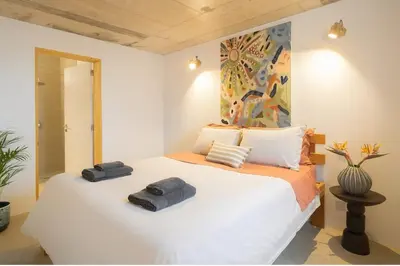 a bedroom with a bed with two towels on it at Casa Alba - Sunrise and Sea View Balcony - Apt 1 in Seixal