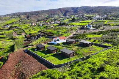 an aerial view of a farm with houses on a hill at Sunset Eco Shelter 1 in Ponta do Pargo