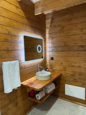 a wooden bathroom with a sink and a mirror at Sunset Eco Shelter 1 in Ponta do Pargo
