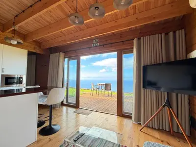 a living room with a view of the ocean at Sunset Eco Shelter 1 in Ponta do Pargo