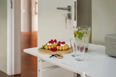 a kitchen with white cabinets and a counter top at Casa da Camélia in Funchal