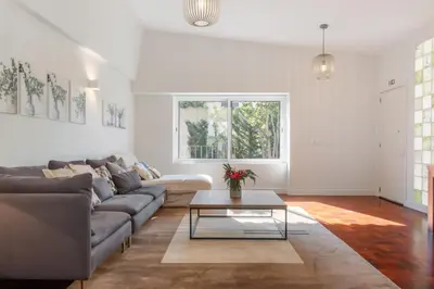 a living room with a couch and a table at Casa da Camélia in Funchal