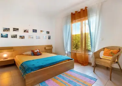 a bedroom with a bed and a desk and a chair at Casa de Praia na Carrapateira in Bordeira