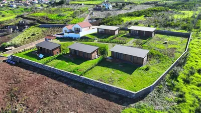 an aerial view of a house with a yard with grass at Sunset Eco Shelter 2 in Ponta do Pargo