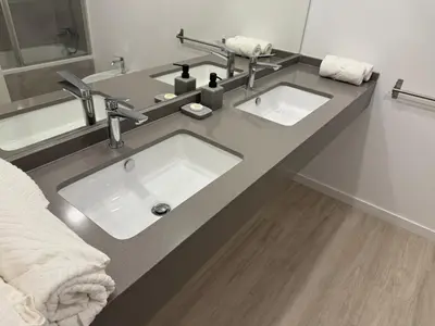 a bathroom with a sink and two mirrors at Penteada Golden Residence in Funchal