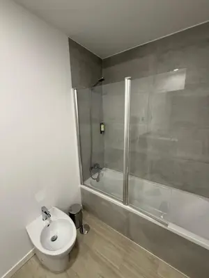 a bathroom with a toilet and a shower and a sink at Penteada Golden Residence in Funchal