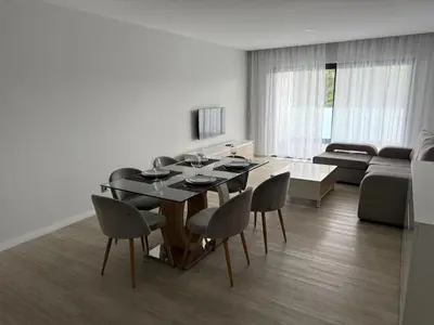 a dining room with a table and chairs and a couch at Penteada Golden Residence in Funchal