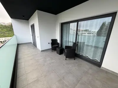 an empty room with two chairs and a large window at Penteada Golden Residence in Funchal