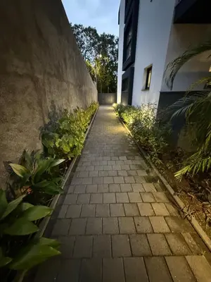 a brick walkway in front of a building with plants at Penteada Golden Residence in Funchal