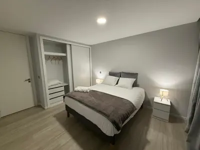 a bedroom with a large bed with two lamps on it at Penteada Golden Residence in Funchal