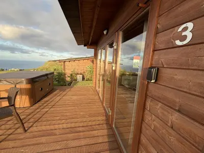 a house with a deck with a number on it at Sunset Eco Shelter 3 in Ponta do Pargo