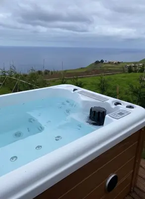 a bath tub with a view of the ocean at Sunset Eco Shelter 3 in Ponta do Pargo