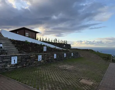 a building on top of a hill with stairs at Sunset Eco Shelter 3 in Ponta do Pargo