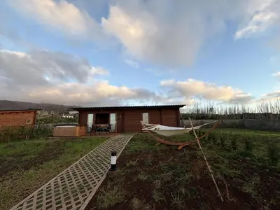a small house with a hammock in the yard at Sunset Eco Shelter 4 in Ponta do Pargo