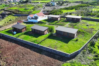an overhead view of a house with a yard with grass at Sunset Eco Shelter 4 in Ponta do Pargo