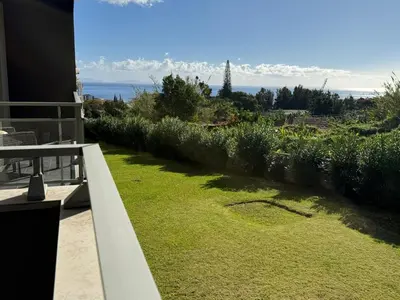 a kitchen with a washing machine and a microwave at Madeira Sun Loft in Funchal in Funchal