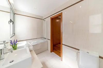 a bathroom with a sink and a tub and a toilet at Villa Sol e Mar Dio by Villa Plus in Caniço