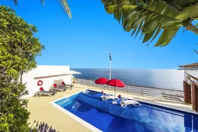 a swimming pool with a view of the ocean at Villa Sea Shore Dio by Villa Plus in Gaula