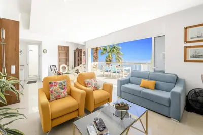 a living room with two chairs and a blue couch at Villa Sea Shore Dio by Villa Plus in Gaula
