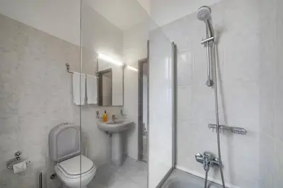 a bathroom with a shower and a toilet and a sink at Villa Casa Amelia Dio by Villa Plus in Caniço