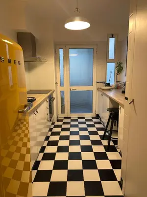 a kitchen with a black and white checkered floor at Lido Sea Apart in Funchal