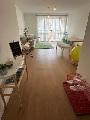 a living room with a wooden floor and a table at Lido Sea Apart in Funchal