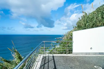 a view of the ocean from a stairway at Infinite Ocean View Villa 20m above Ocean & Beach in Arco da Calheta