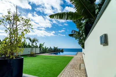 a view of the ocean from the balcony of a house at Infinite Ocean View Villa 20m above Ocean & Beach in Arco da Calheta