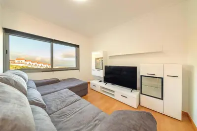 a living room with a couch and a flat screen tv at Assomada Sea Pearl by Mth in Caniço
