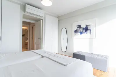 a white bedroom with a large bed and a mirror at Eco Monte by Atlantic Holiday in Funchal