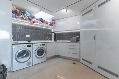 a white laundry room with a washer and dryer at Eco Monte by Atlantic Holiday in Funchal