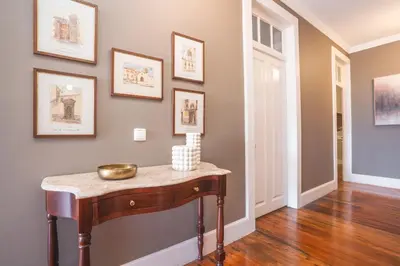 a hallway with a table and pictures on the wall at Casa dos Francelhos by Atlantic Holiday in Funchal